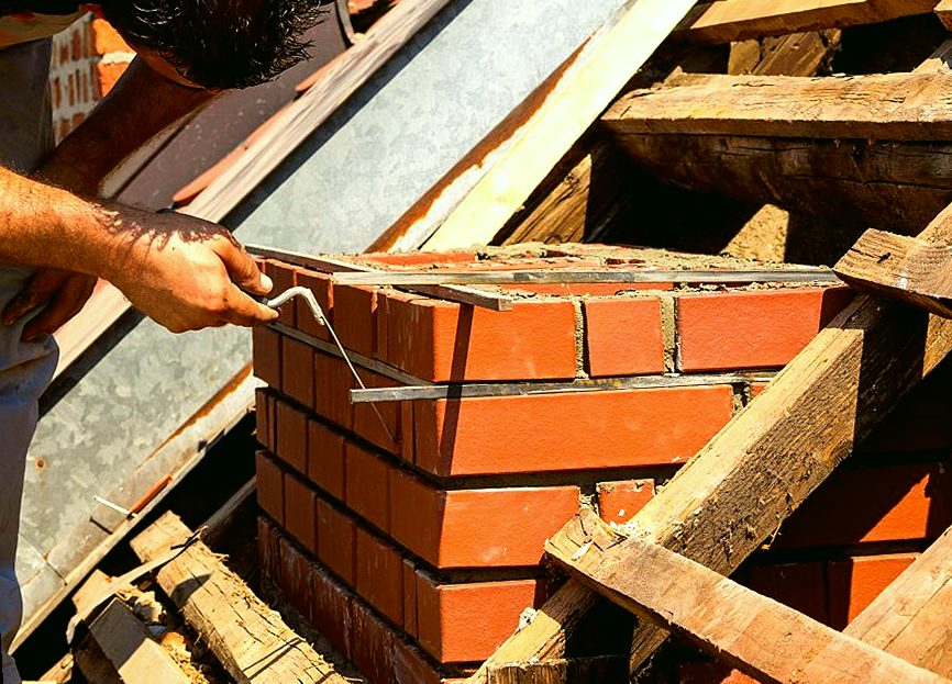 New brick nestling into its mortar bed on a foothill rebuild