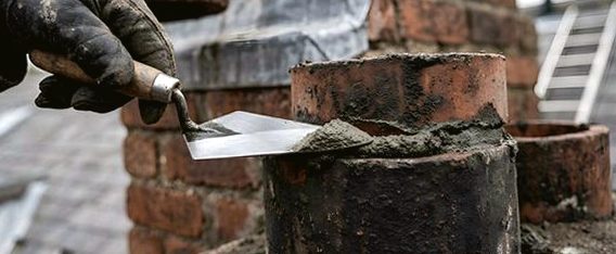 Dressing mortar at a chimney pot collar in the foothills